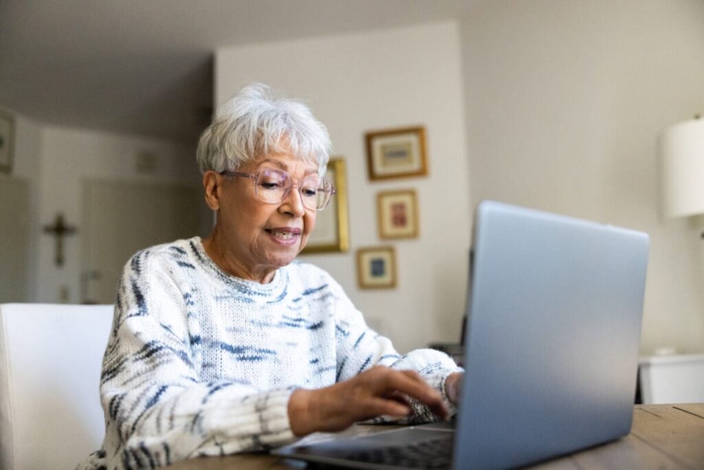 Retirees: 2 TSX Dividend Stocks You Can Probably Hold for 10 Whole Years Senior uses a laptop computer