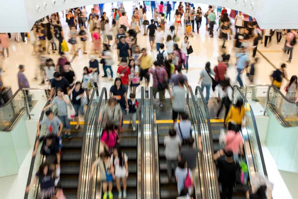 A Top-Tier 6.8% Dividend Stock That Pays Cash Every Month shoppers in an indoor mall