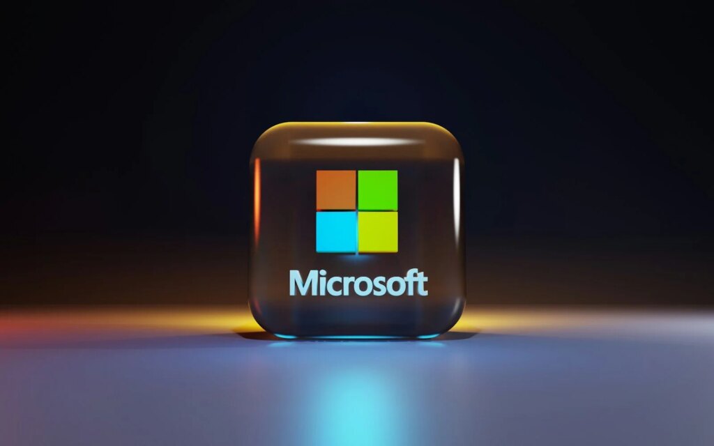 Microsoft Posts Record $92.3B Quarter as AI Demand Lifts Azure to $33.2B A glossy glass cube with the Microsoft logo on a dark surface