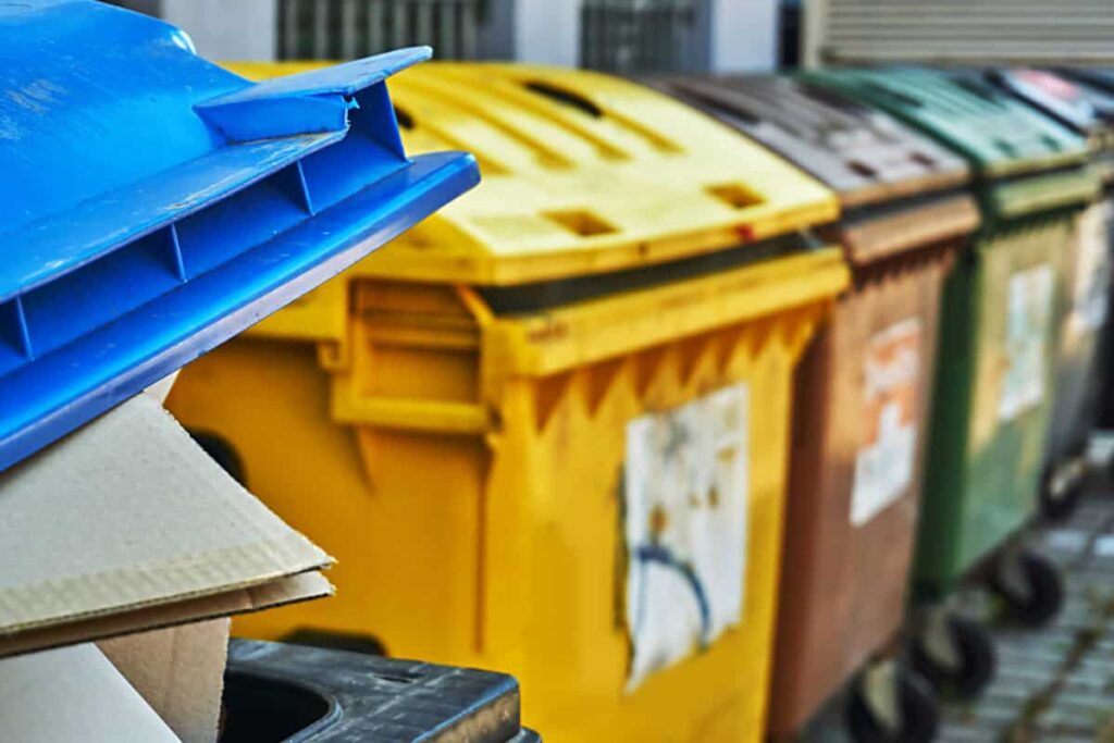 dumpsters sit outside for waste collection and trash removal