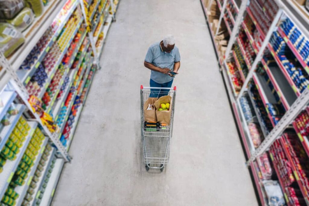 The Best Canadian Stocks for Conservative Investors Right Now man shops at grocery store